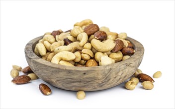 Portion of roasted nuts isolated on white background as close up shot (selective focus)