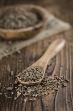 Dried Valerian roots (detailed close-up shot) on wooden background