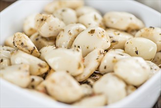 Portion of fresh Preserved Garlic (close-up shot, selective focus)