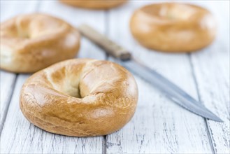 Plain Bagel (selective focus) on vintage background (close-up shot)