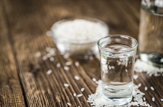 Japanese Sake drink on an old wooden table (close-up shot)