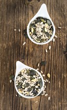 Old wooden table with mixed Seeds (close-up shot, selective focus)