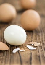 Some boiled Eggs (close-up shot, selective focus) on an old wooden table