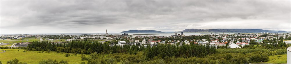 Reykjavik panorama shot from the Perlan observation deck during a cloudy summer day