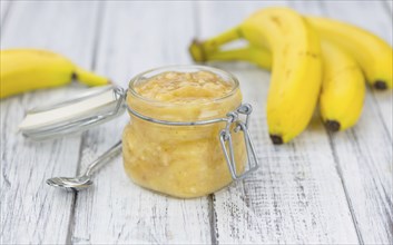 Banana Puree on wooden background (selective focus, close-up shot)