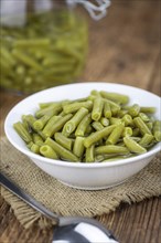 Preserved Green Beans as detailed close-up shot (selective focus) on vintage background