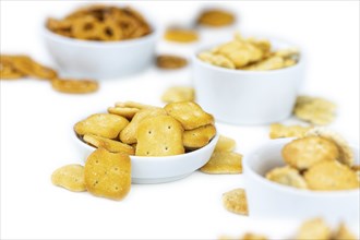 Portion of mixed Snacks isolated on white background (close up shot, selective focus)