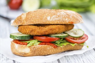 Chicken Schnitzel on a bun (selective focus, detailed close-up shot)