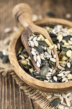 Mixed Seeds (close-up shot, selective focus) on vintage wooden background