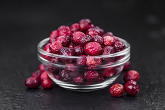 Portion of fresh made Dried Cranberries on a slate slab (selective focus)