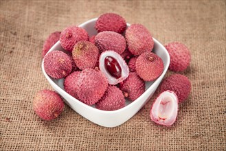 Lychees on a vintage background as detailed close-up shot (selective focus)