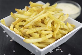 Portion of fresh made French Fries (close-up shot, selective focus)