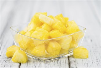 Sliced Pineapple on rustic wooden background as close-up shot