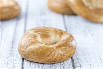 Plain Bagel (selective focus) on vintage background (close-up shot)