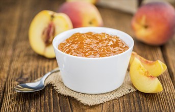 Portion of fresh Peach Jam close-up shot, selective focus