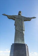 Christ the Redeemer statue in Rio de Janeiro, Brazil with blue sky in the background