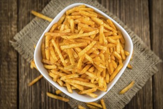 Potato Sticks (close-up shot, selective focus) on an old wooden table