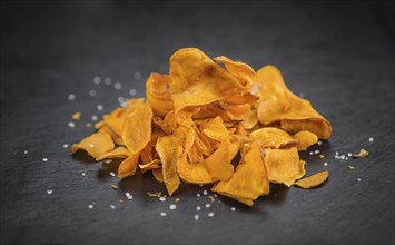 Homemade Sweet Potato Chips on vintage background selective focus, close-up shot