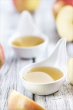 Portion of fresh made Applesauce (selective focus) on wooden background