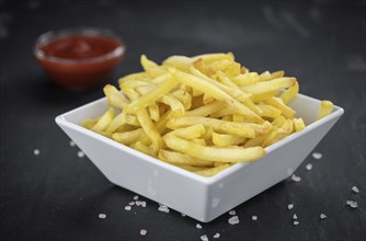 Portion of homemade French Fries (close-up shot, selective focus)