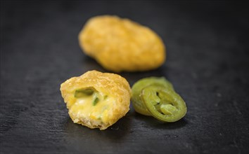 Homemade Cheese Nuggets (with Chilis) on vintage background (selective focus, close-up shot)