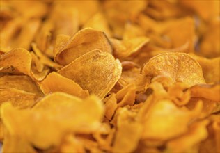 Homemade Sweet Potato Chips on vintage background selective focus, close-up shot