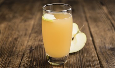 Apple Juice on a vintage background as detailed close-up shot (selective focus)