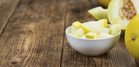 Honeydew Melon on an old wooden table as detailed close-up shot (selective focus)