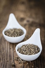 Valerian roots (dried, detailed close-up shot) on wooden background