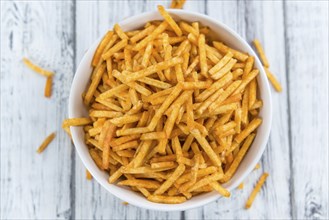 Potato Sticks (close-up shot, selective focus) on an old wooden table