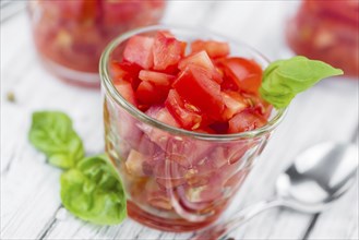 Cutted Tomatoes on an old wooden table as detailed close-up shot (selective focus)