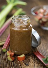 Rhubarb Jam on an old wooden table as detailed close up shot (selective focus)