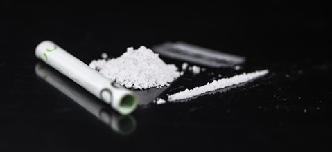 Cocaine on a dark plate as detailed close-up shot