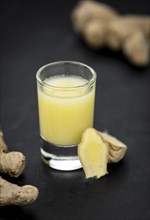 Fresh made Ginger Drink on a slate slab (close-up shot, selective focus)