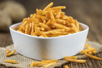 Portion of fried potato sticks (close-up shot, selective focus)