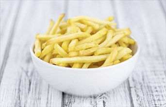 Portion of fresh made French Fries (close-up shot, selective focus)