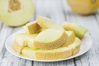 Honeydew Melon on a vintage background as detailed close-up shot (selective focus)