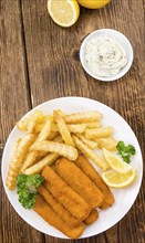 Fisch Sticks (close-up shot) on an old wooden table (selective focus)