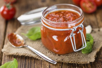 Fresh made Pasta Sauce (Tomato taste) on a vintage background (close-up shot)