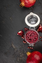 Portion of healthy preserved Pomegranate seeds on a slate slab (selective focus)