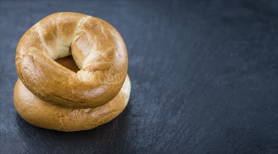 Plain Bagel (selective focus) on vintage background (close-up shot)