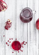 Pomegranate juice on a vintage background as detailed close-up shot (selective focus)