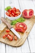 Homemade Cutted Tomatoes on vintage background (selective focus, close-up shot)