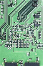 Green PCB (printed circuit board) close-up shot with a lot of electronic components