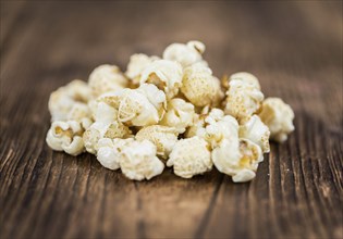 Fresh made Popcorn on a vintage background as detailed close-up shot