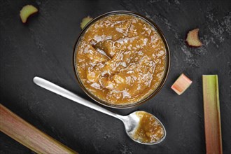 Homemade Rhubarb Jam on rustic background (close up shot, selective focus)