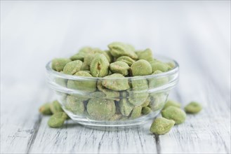 Wasabi Peanuts on a vintage background as detailed close-up shot (selective focus)