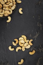 Portion of roasted Cashew Nuts (close up shot, selective focus)