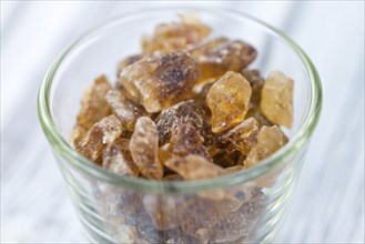 Brown Rock Candy on wooden background (selective focus, close-up shot)