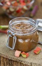 Homemade Rhubarb Jam on rustic background (close up shot, selective focus)